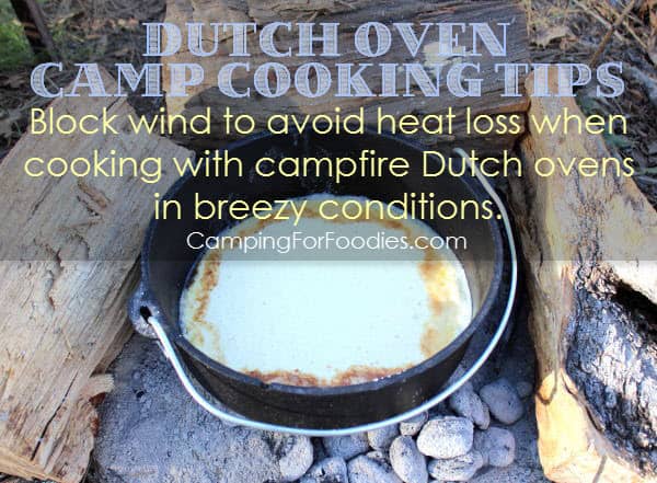 Dutch Oven Camp Cooking Tips - Block wind to avoid heat loss when cooking with campfire Dutch ovens in breezy conditions for this lemon blueberry topped campfire dutch baby easy recipe - Camping For Foodies .com