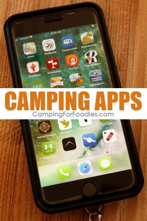 The Best Camping Apps For RV And Tent Camping by CampingForFoodies is a photo of an iphone sitting on a wooden board with various camping app icons lit up on the screen.