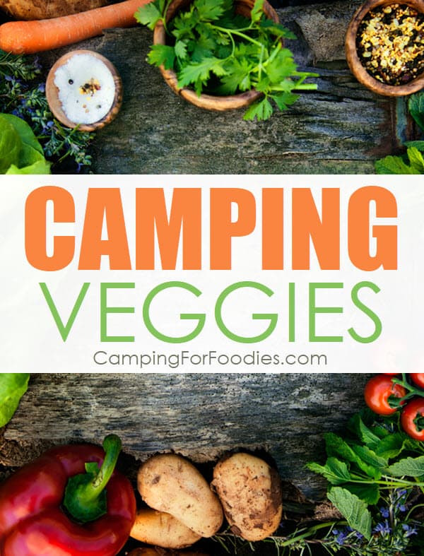 Camping veggies and how to keep food fresh while camping by CampingForFoodies is an image of bright and colorful fresh raw vegetables scattered on a rustic wooden table ready to be prepared for a camping meal with text over the image that reads camping veggies.