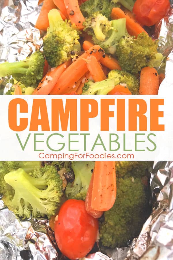 Campfire Vegetables by CampingForFoodies features a foil pack of cooked vegetables including broccoli, carrots, cherry tomatoes and garlic ready to be served at the campsite and text over the image that reads campfire vegetables.