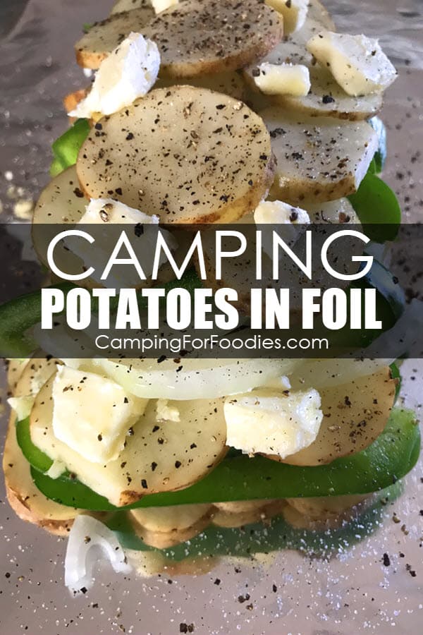 Camping Potatoes In Foil by CampingForFoodies features a camping side dish that is sitting on a large piece of aluminum foil ready to be cooked that includes sliced potatoes and green bell peppers seasoned with garlic, butter salt and pepper with text over the image that reads camping potatoes in foil.