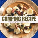 Fruit And Nut Peanut Butter Stuffed Tortilla Camping Recipe by CampingForFoodies features a whole wheat tortilla laying on a blue camping plate with peanut butter, banana slices, dried fruit, nuts and seeds layered on top and ready to be rolled up to be eaten with text over the image reading camping recipe.