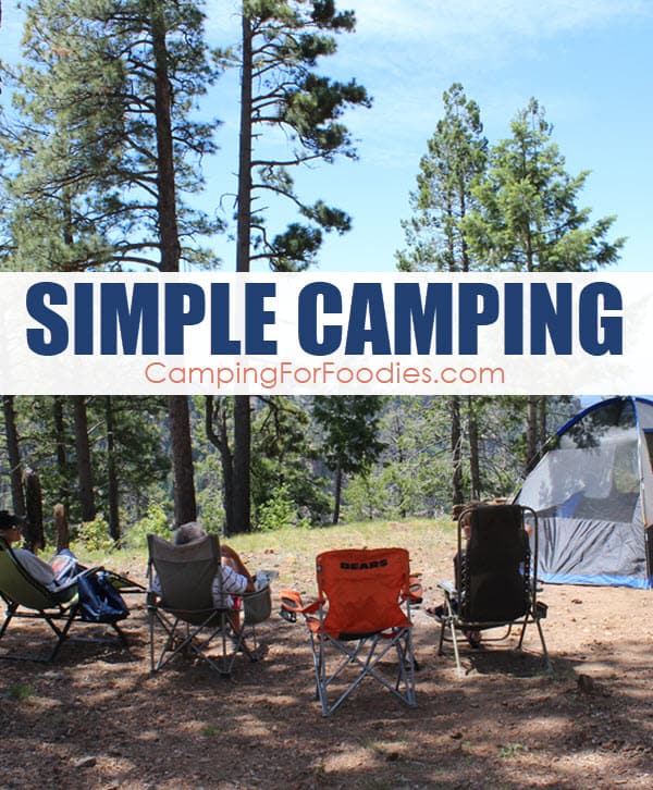 Simple Camping by CampingForFoodies features a beautiful sunny day camp scene in a forest with people sitting in camp chairs that are shaded by mature pine trees with views that are overlooking a massive natural mountain rim with a single tent set up in the background and text over the image that reads simple camping.