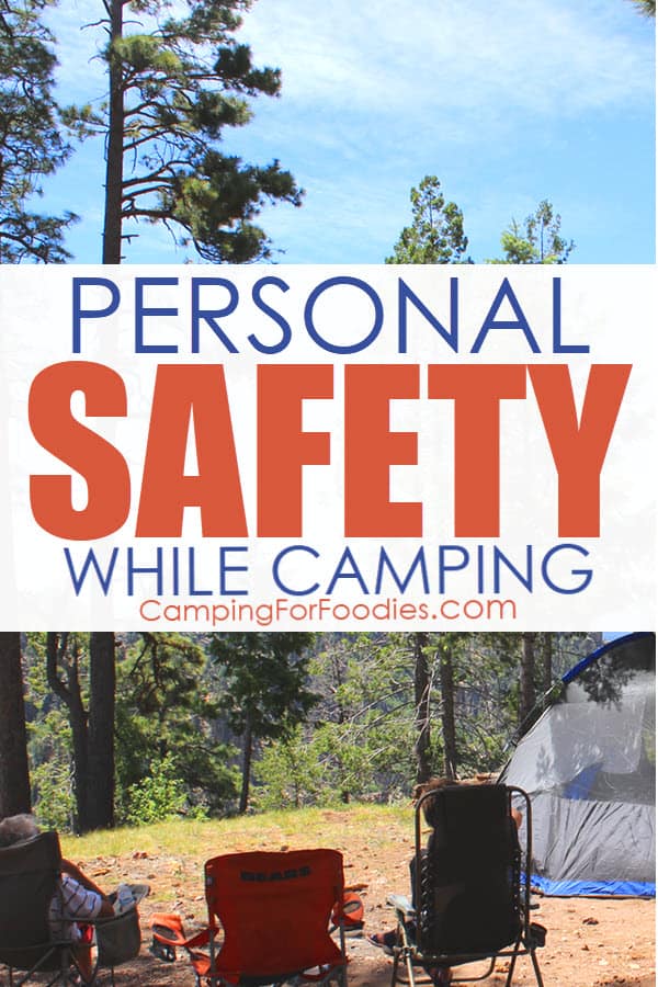 911 Personal Safety While Camping by CampingForFoodies features a camp scene in a remote wooded area in the mountains with three camp chairs set up and two people relaxing in them next to a tent under a bright blue sky with text over the image that reads personal safety while camping.