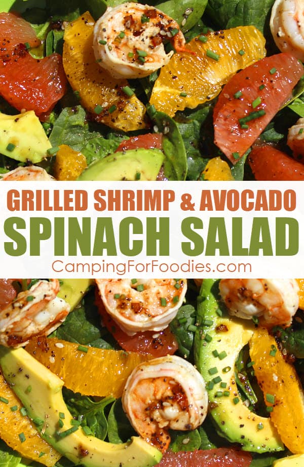 Grilled Shrimp And Avocado Spinach Salad by CampingForFoodies features a plate full of green spinach that is topped with grilled shrimp and slices of green avocado, juicy orange segments and succulent ruby red grapefruit segments covered with a fresh dressing made with red onion, poppy seeds, sesame seeds, olive oil and balsamic vinegar then sprinkled with fresh chives. The text over the image reads grilled shrimp and avocado spinach salad.