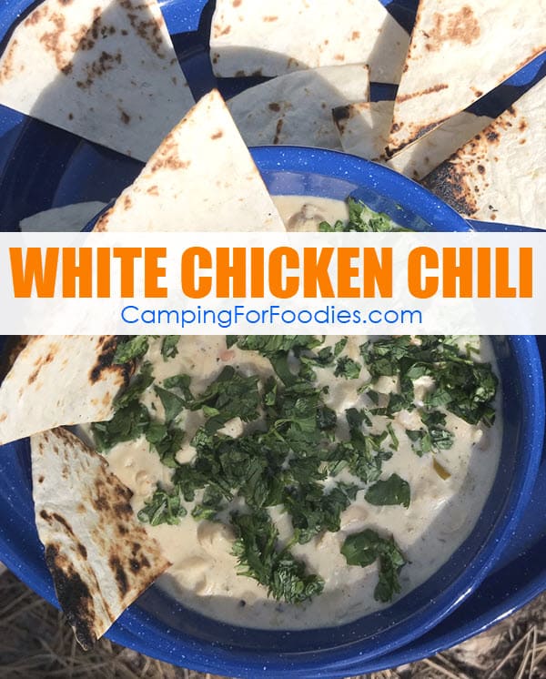 White Chicken Chili Dutch Oven Camping Recipe by CampingForFoodies features a blue camping bowl filled with rich and creamy white chicken chili, on a blue camping plate with toasted wedges of flour tortillas with text over the image that reads white chicken chili.