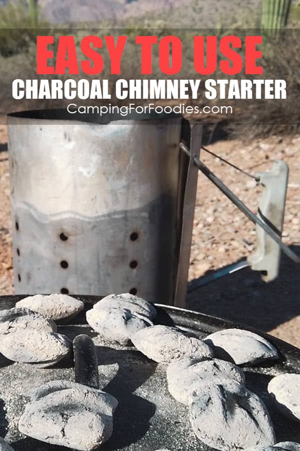 Easy To Use Charcoal Chimney Starter by CampingForFoodies features a cast iron camp Dutch oven with hot charcoals on the lid sitting in front of a charcoal chimney starter at a campsite in the Sonoran Desert with Jumping Cholla, Saguaro Cactus and mountains in the background with text over the image that reads Easy To Use Charcoal Chimney Starter.