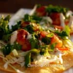 Chili Lime Shrimp Tacos by CampingForFoodies features a corn tortilla topped with chili lime marinated shrimp that's grilled to golden brown color, served with slaw and drizzled with jalapeno lime sauce.